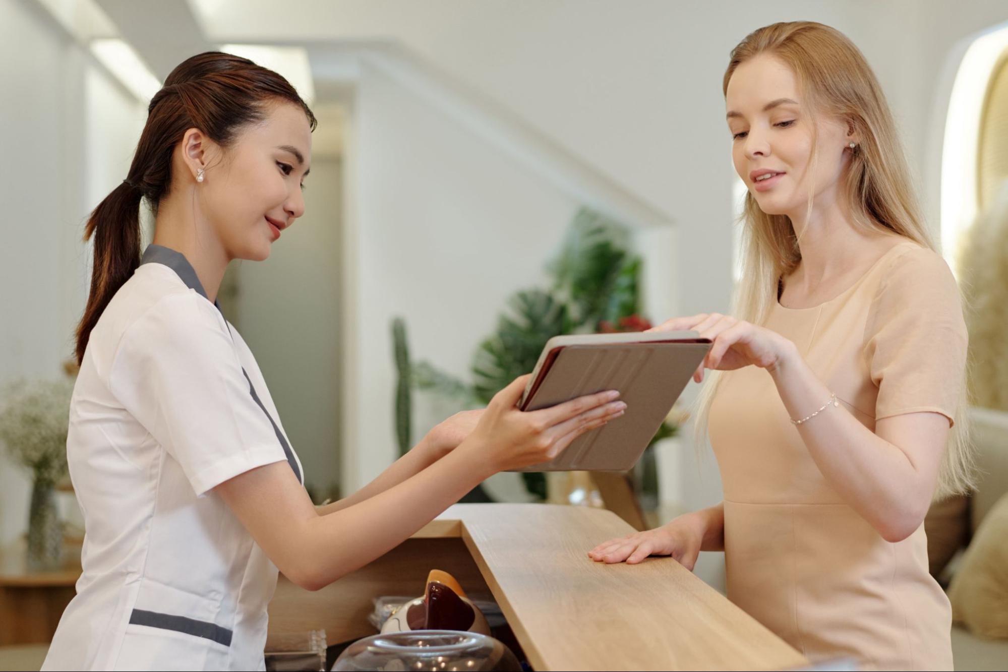 A beauty consultant discussing medspa treatment plans and budgeting options with a client.