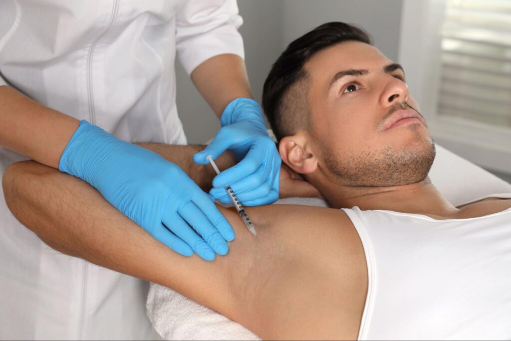 Close-up of a patient receiving neurotoxin injections for excessive sweating treatment.