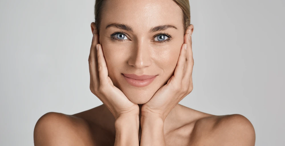 Woman with glowing, smooth skin after Daxxify treatment