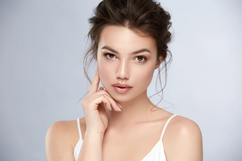 Woman with glowing skin after dermal fillers treatment.