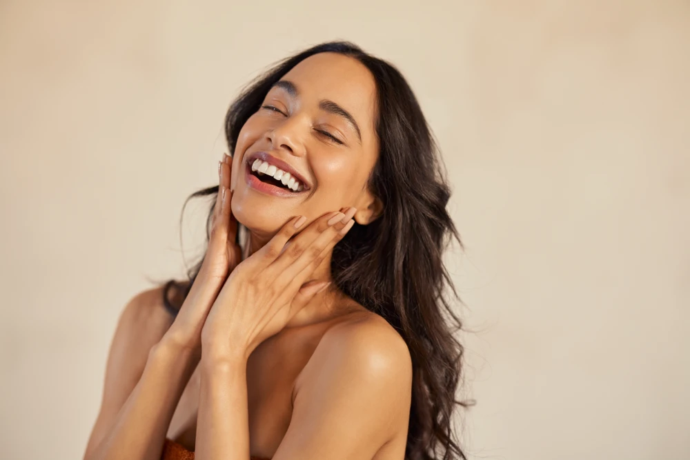 Woman smiling with radiant skin after DiamondGlow treatment.