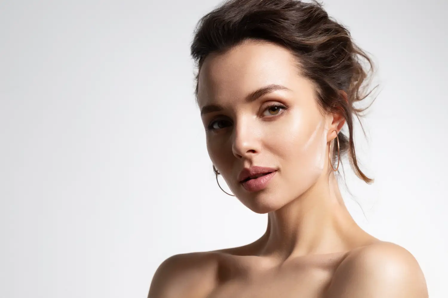 woman with glowing skin and natural facial contours after aesthetic treatment