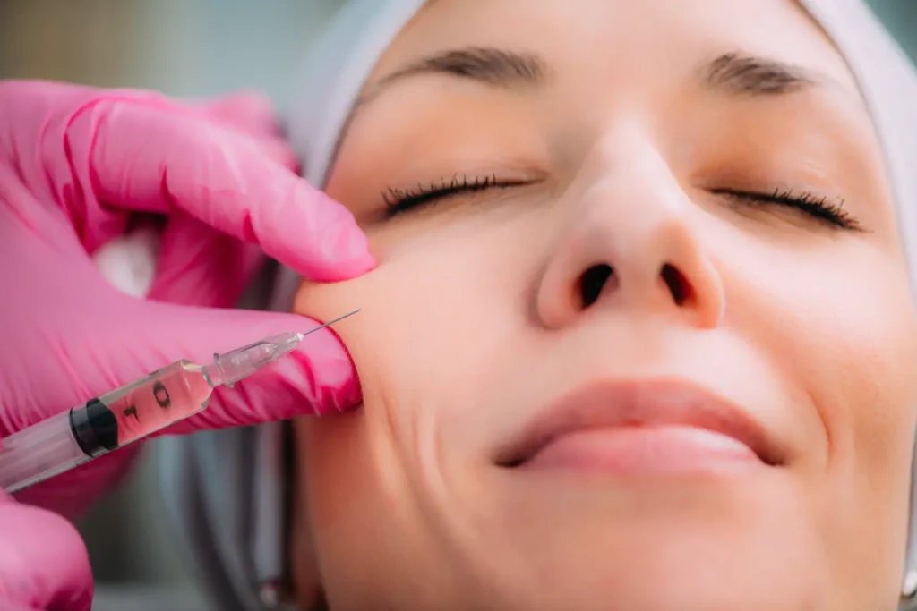 practitioner performing cheek injection to stimulate collagen production