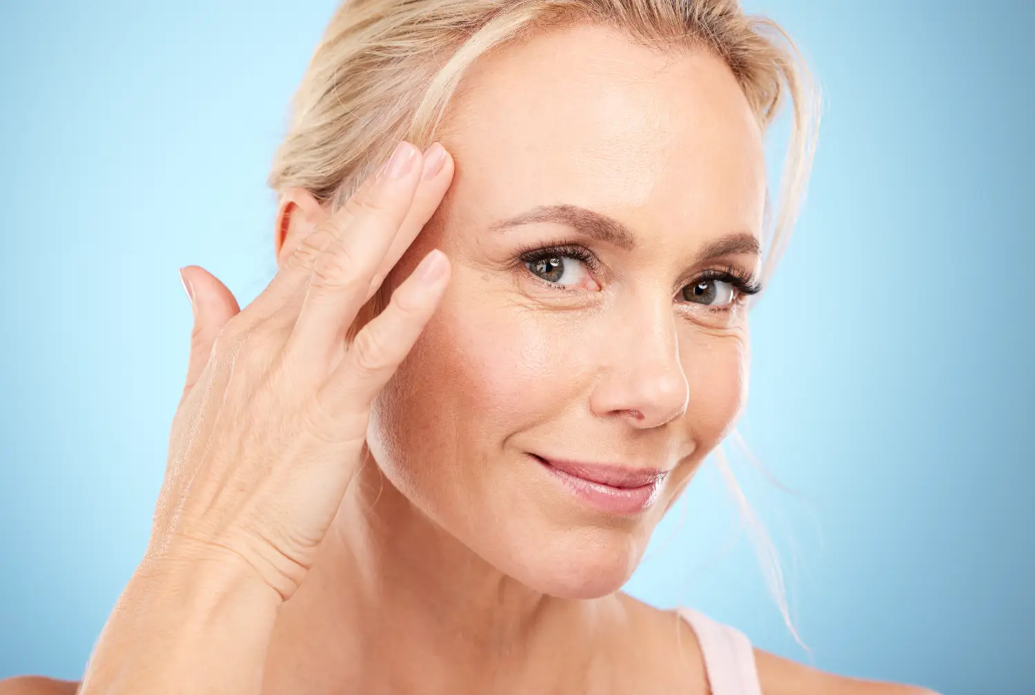 woman touching temple showing smooth skin after Botox treatment